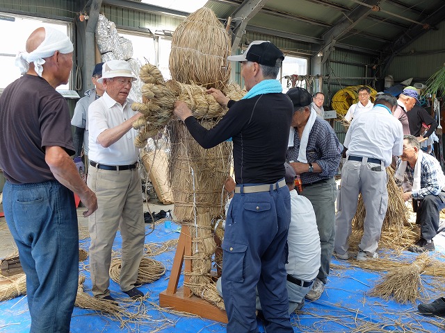 写真：鹿嶋様に腕を固定する住民