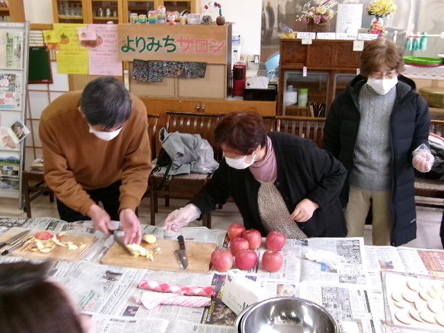 りんごの皮むきをする人々