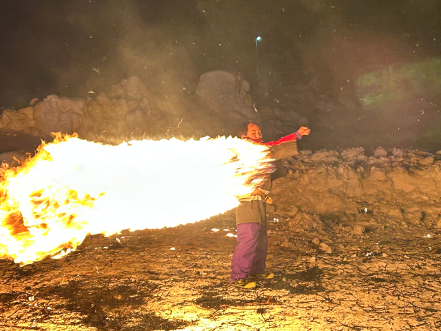 画像：火をつけた炭俵をまわす子供たち